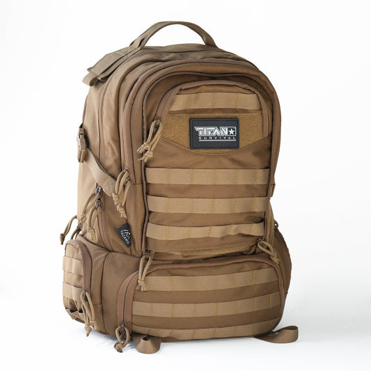The TACAMO BC50 72-Hour Tactical Backpack by TITAN Survival features multiple zippered compartments, MOLLE webbing, side pockets, and a front Titan Survival patch—shown standing upright against a white background.