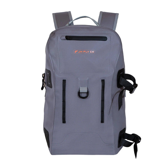 The JHFLYCO 27L Waterproof Backpack by Jackson Hole Fly Company features gray 500D PVC, black straps, a TIZIP front pocket, orange JH FLY CO logo, and multiple side and front attachment points—ready for the wild.