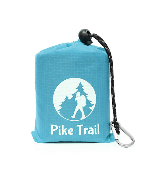 The Pike Trail Pocket Blanket is a compact blue pouch with a drawstring and carabiner, featuring a hiker and pine tree logo—perfect for carrying your packable outdoor blanket on any adventure.