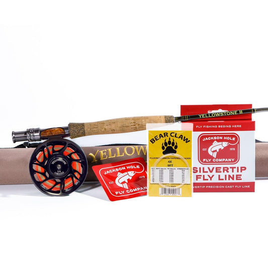 The Jackson Hole Fly Company Missouri River Rod Combo Kit includes an 86 5WT rod, orange/black reel, rod case, fly line packaging, flies, and more—precision gear for dry fly and nymph fishing.