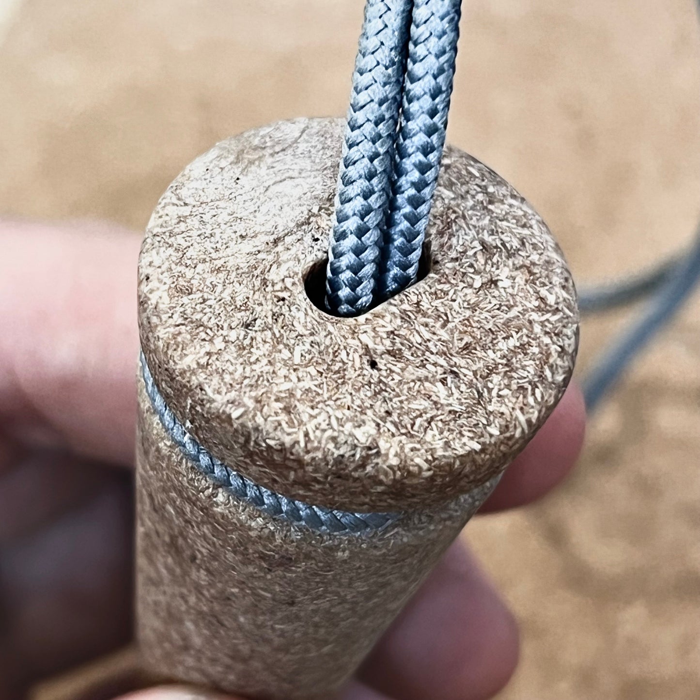 Close-up of a hand holding the Überleben Zünden PRO, a modern flint & steel fire starter by Überleben—crafted with care and made in the USA.