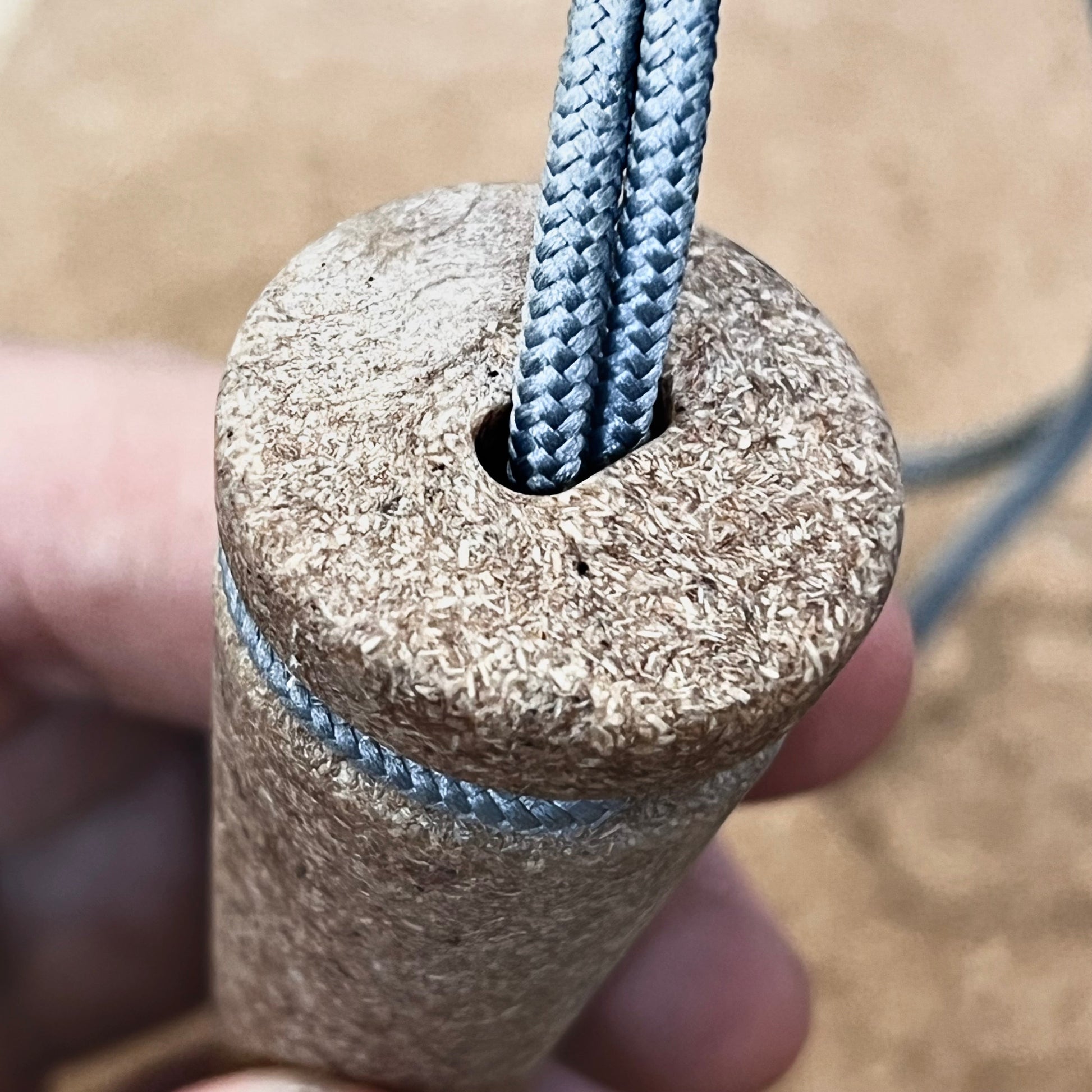 Close-up of a hand holding the Überleben Zünden PRO, a modern flint & steel fire starter by Überleben—crafted with care and made in the USA.