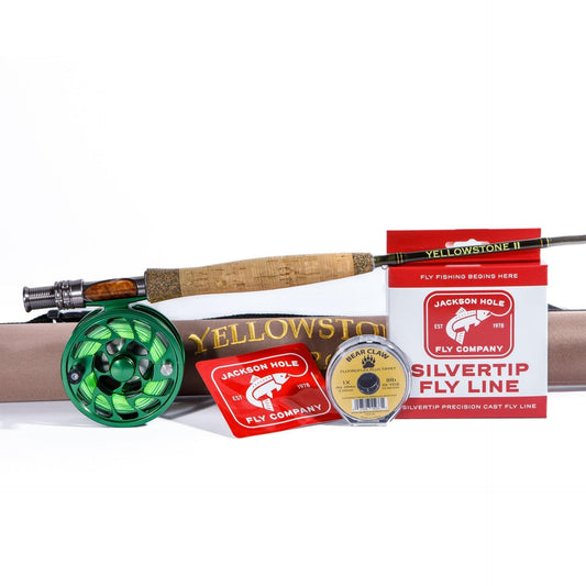 The Jackson Hole Fly Company White River 7WT Streamer Rod Combo Kit, featuring a green reel, tan case, stickers, yellow Bear Claw leader line, and Silvertip sink tip fly line box, is arranged on a white background.